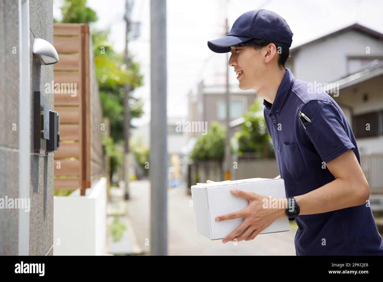 Courier carrying a package Stock Photo Alamy