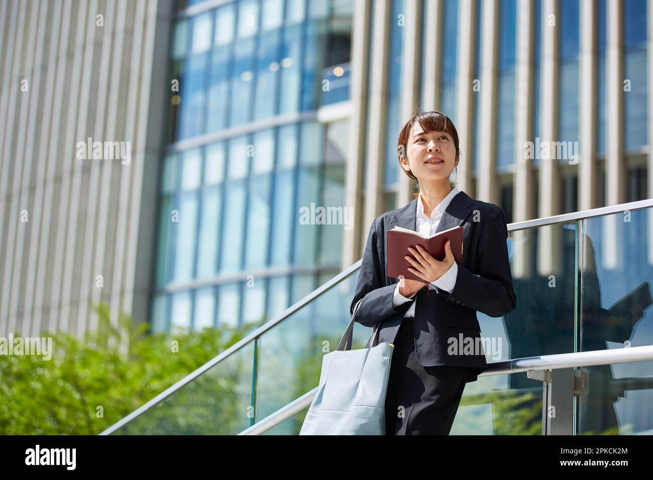 Woman walking outside building hi-res stock photography and images - Alamy