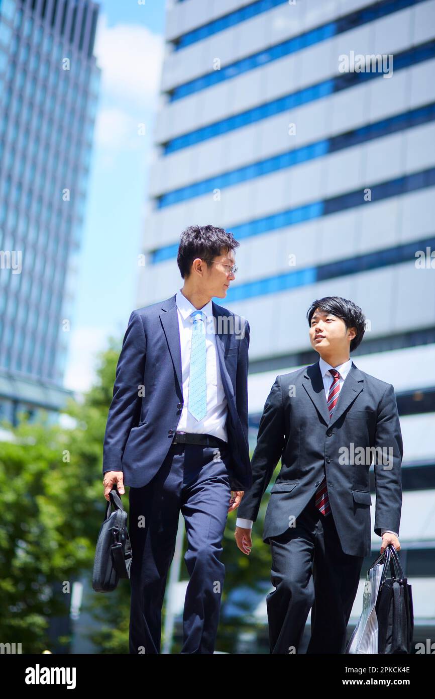 Businessmen in suits walking side by side Stock Photo - Alamy