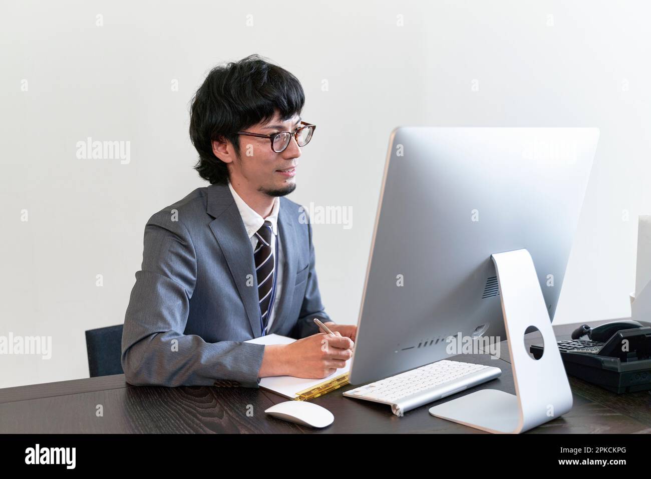 A male interviewer conducting an online interview on a computer Stock Photo