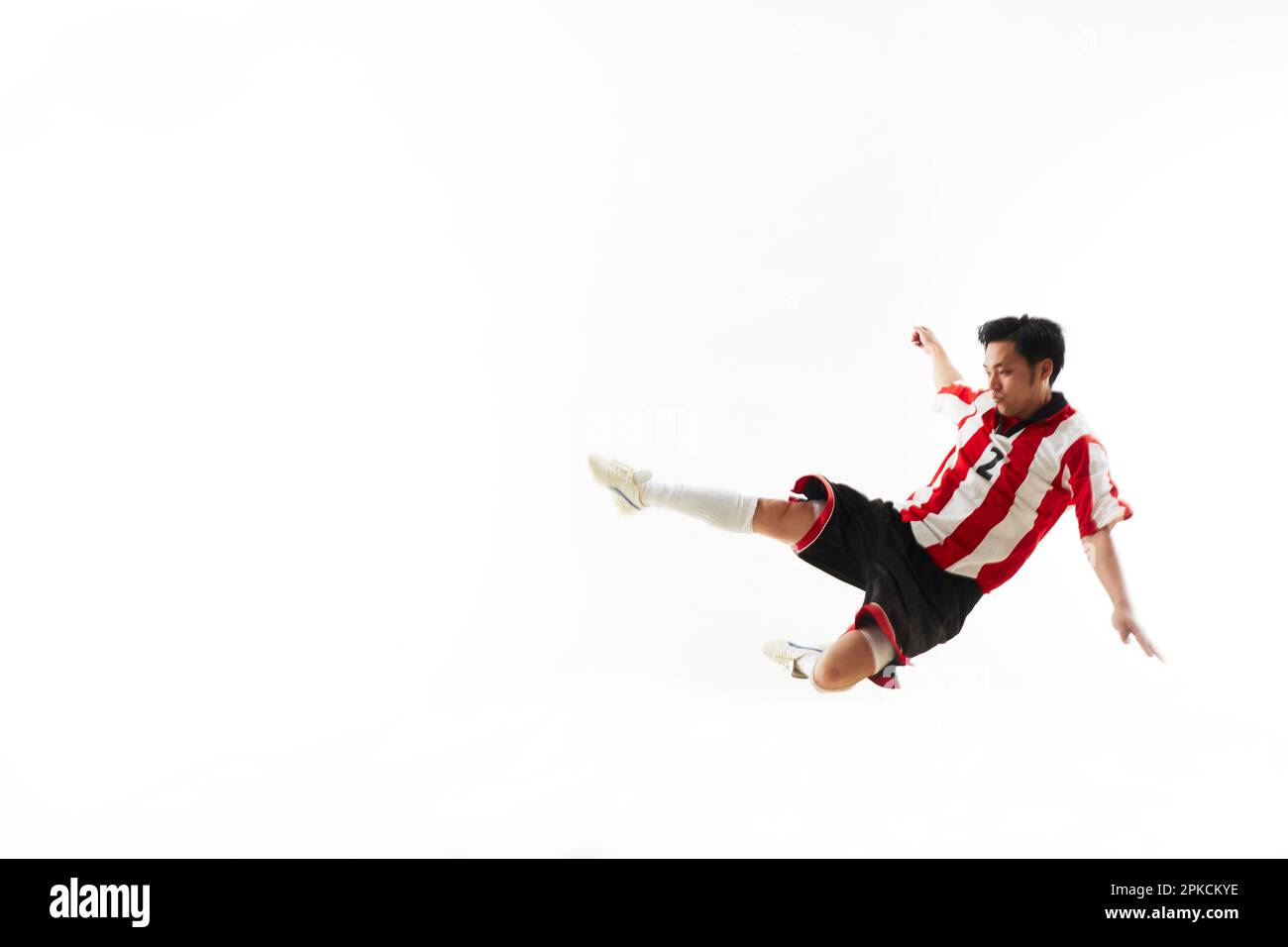 Soccer player sliding Stock Photo