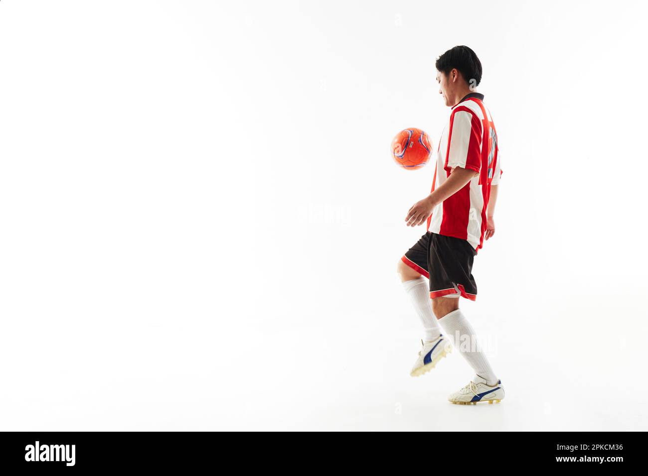 Soccer player lifting a ball Stock Photo