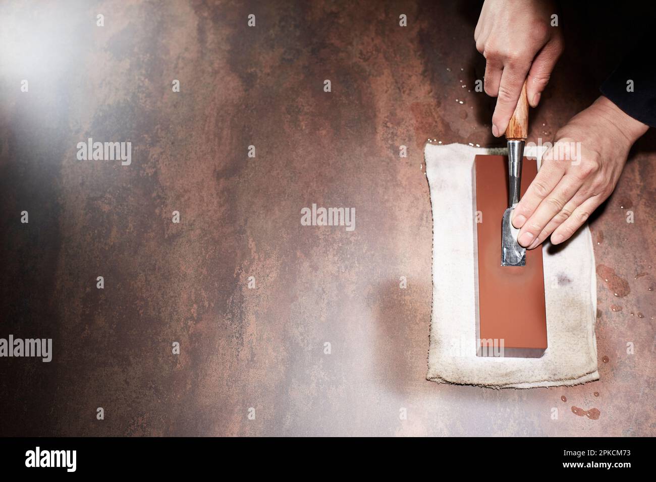 Male hand sharpening a chisel Stock Photo Alamy