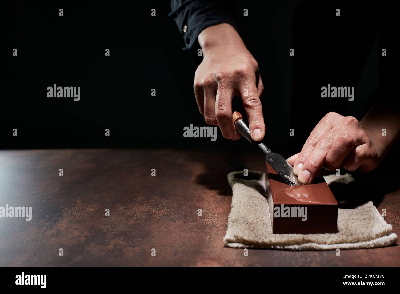 Male hand sharpening a chisel Stock Photo Alamy