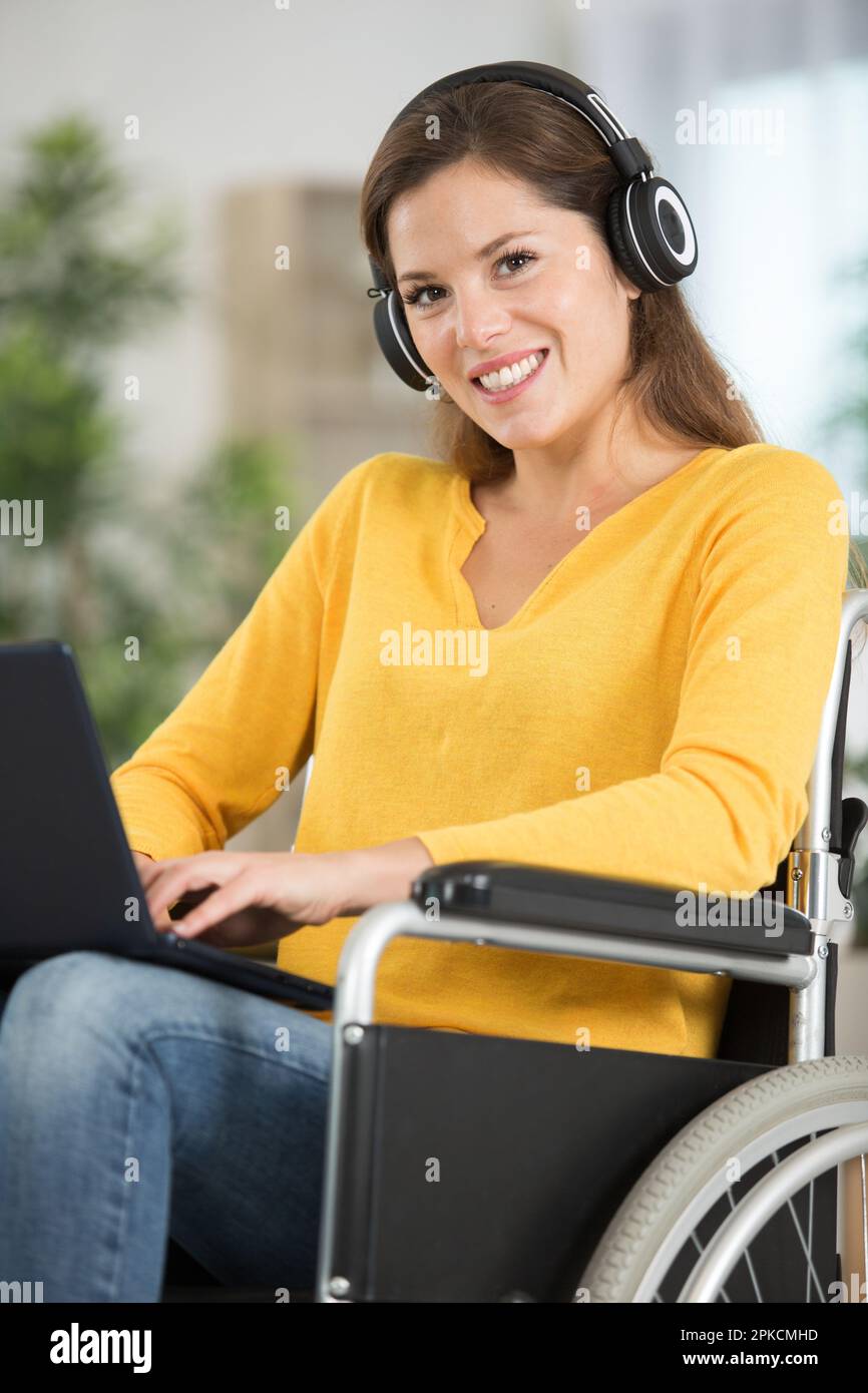 happy disabled woman in wheelchair with laptop Stock Photo - Alamy