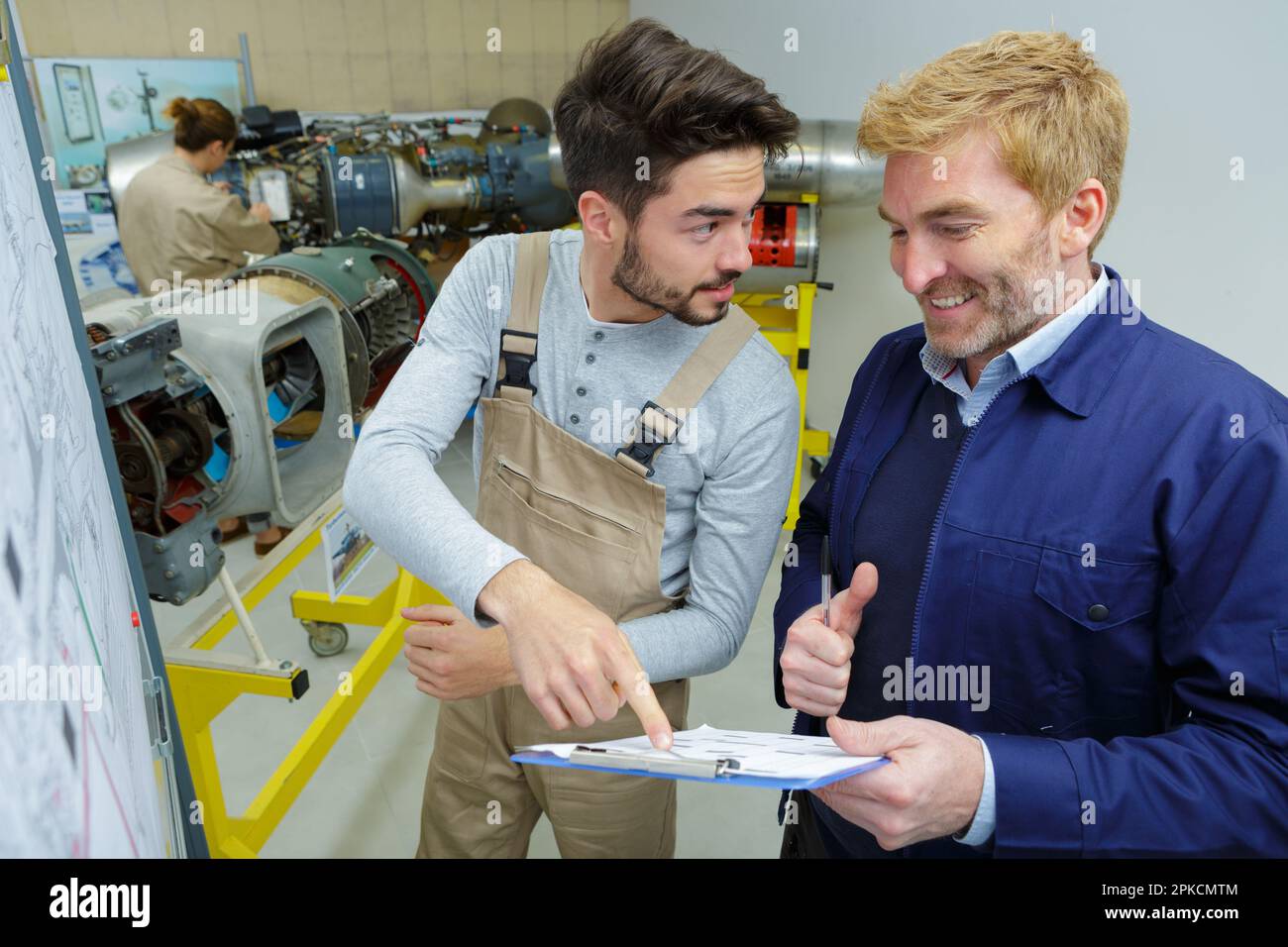 engineers discussing something in control room Stock Photo