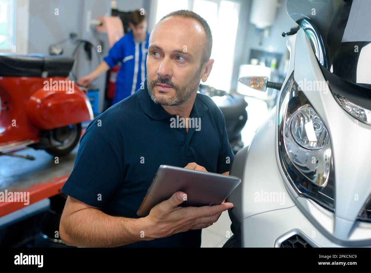 man fixing a motorcycle frame in Stock Photo Alamy