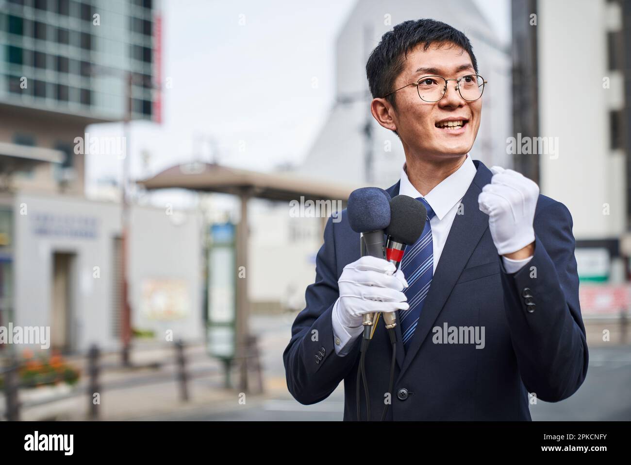 Man in suit giving a speech in the street Stock Photo