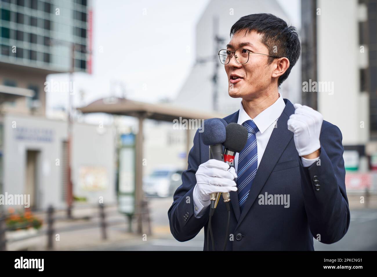 Man in a suit giving a speech in the city Stock Photo