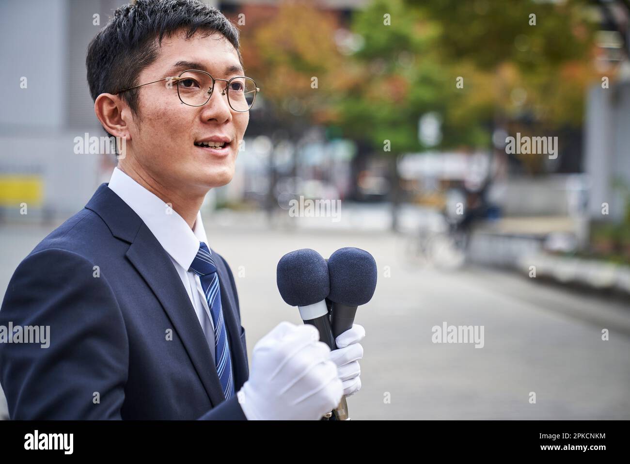 A man in a suit giving a speech in the city Stock Photo
