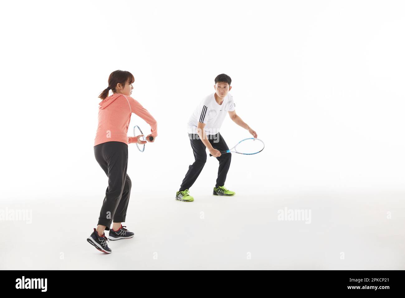 Men and women holding rackets in tennis doubles Stock Photo Alamy
