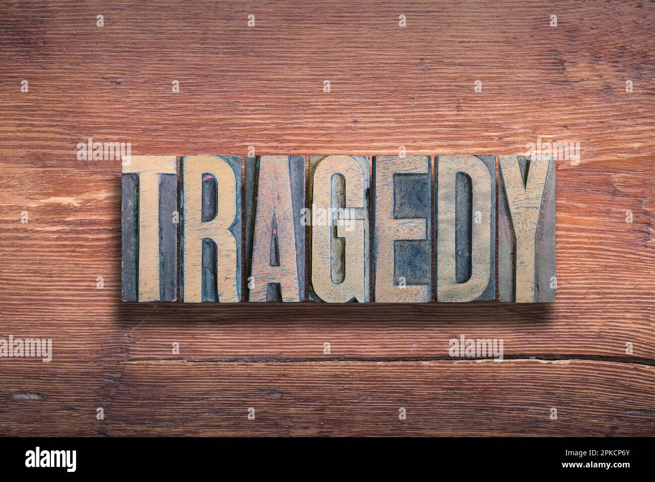 tragedy word combined on vintage varnished wooden surface Stock Photo