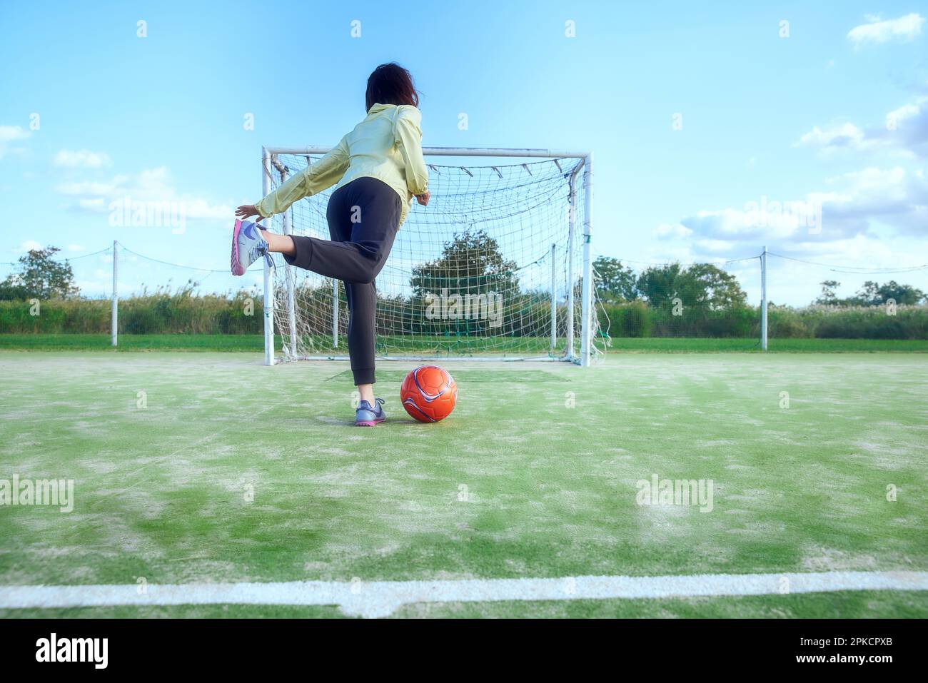 A female soccer player shooting a ball Stock Photo Alamy