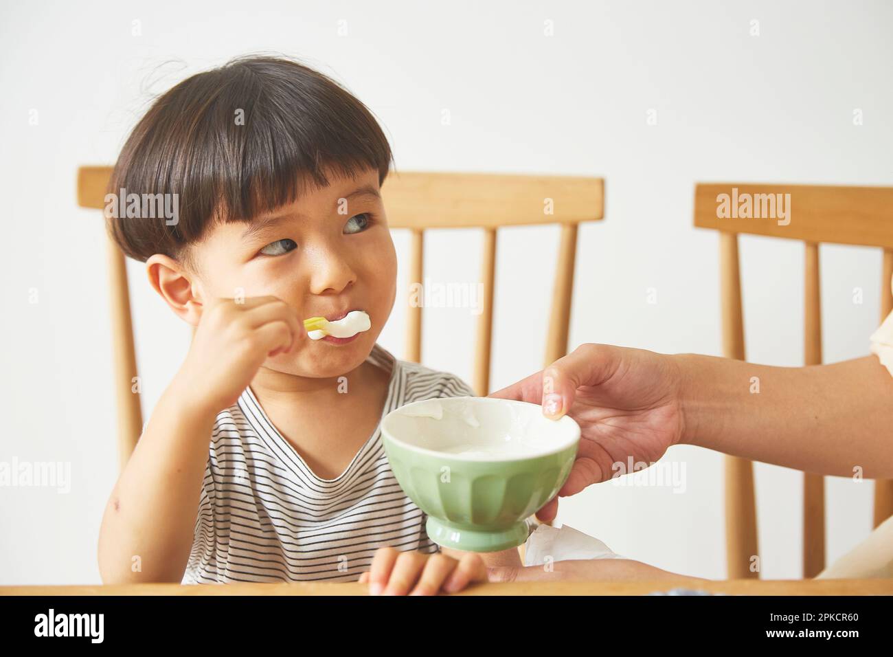 Boy eating yogurt Stock Photo