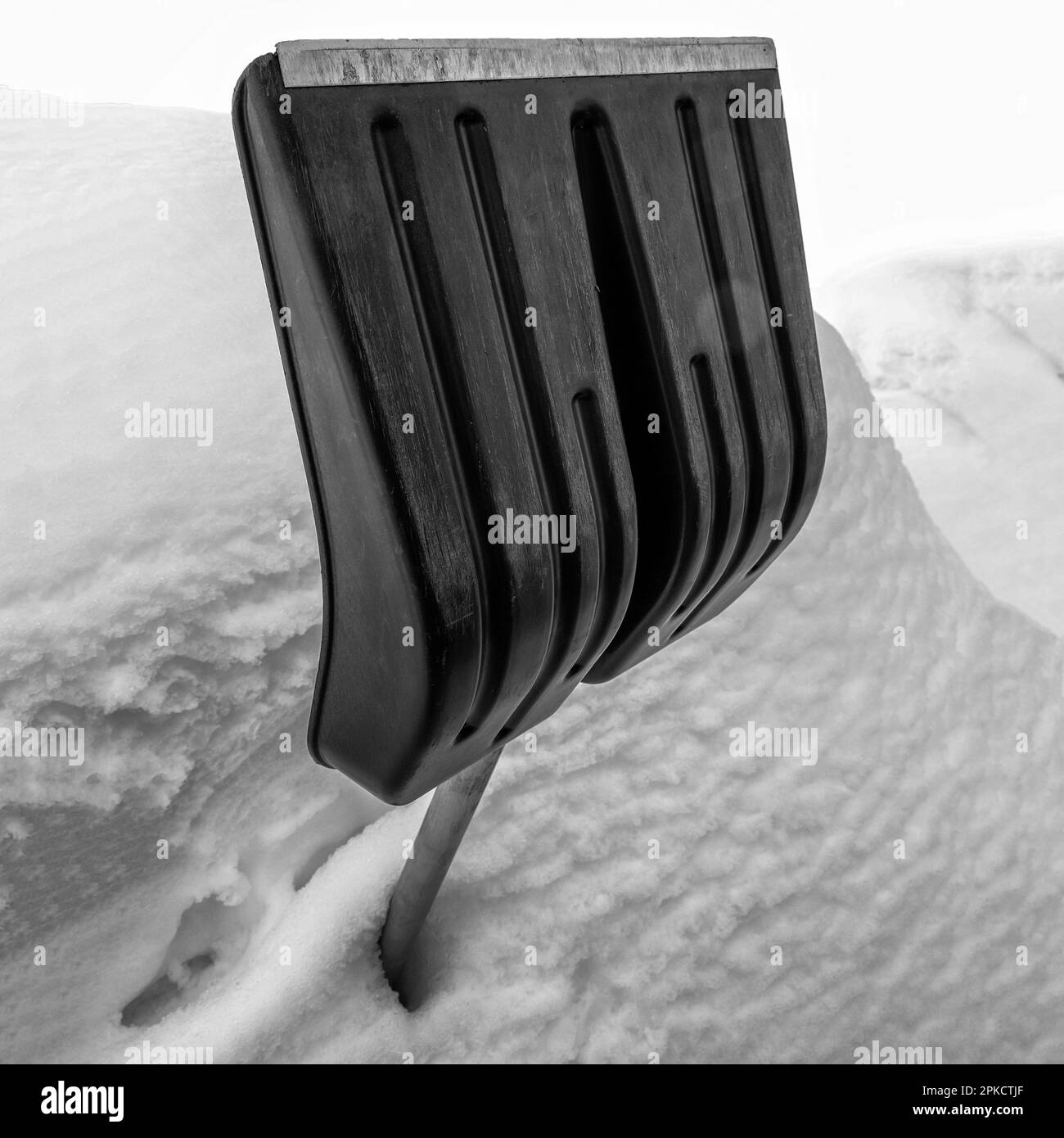 Snow shovel in the snowdrift during the blizzard. Shovel for cleaning