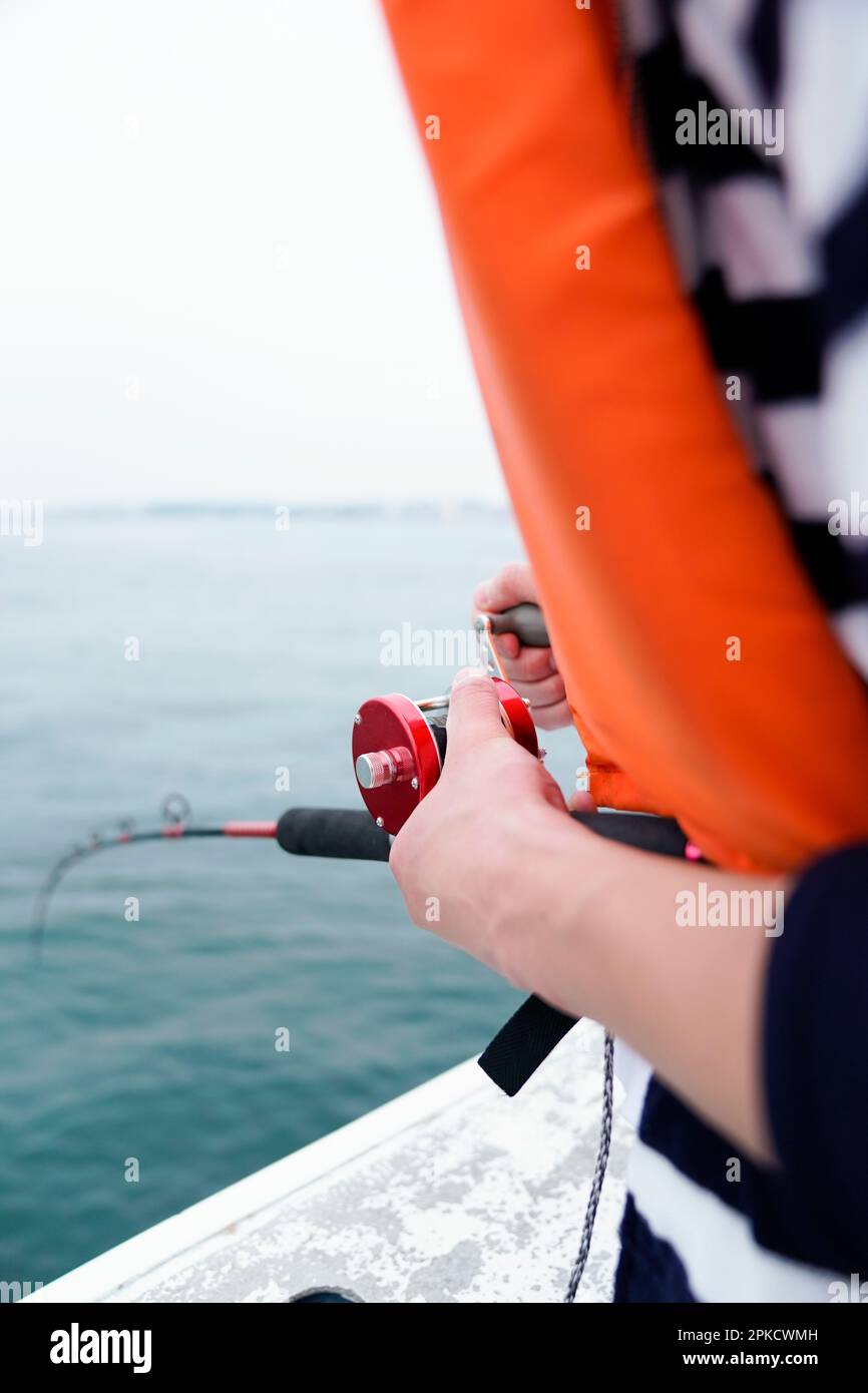 Hand holding fishing rod Stock Photo Alamy