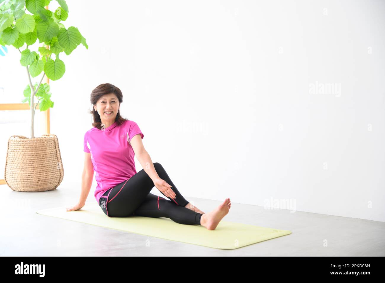 Middle aged woman doing yoga hi-res stock photography and images - Alamy