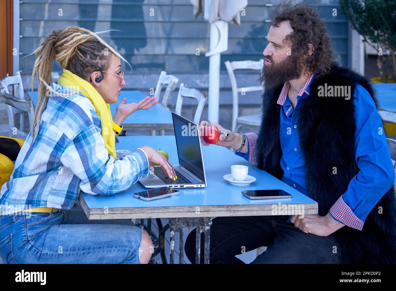 Young extravagant couple communicating at the cafe table Stock Photo