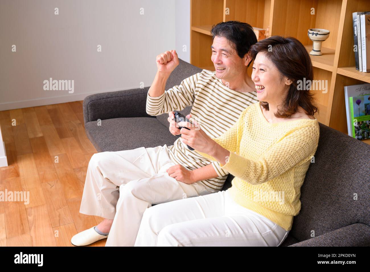 A middle-aged couple playing video games Stock Photo