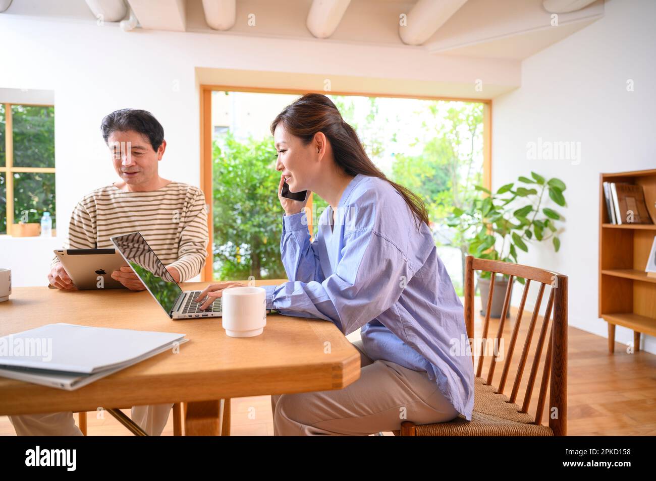 Teleworking middle-aged and older couples Stock Photo