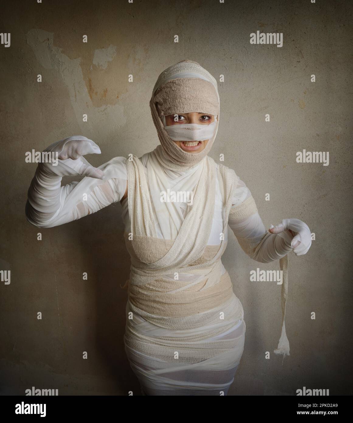 woman wrapped in bandages as egyptian mummy halloween costume fletching teeth Stock Photo