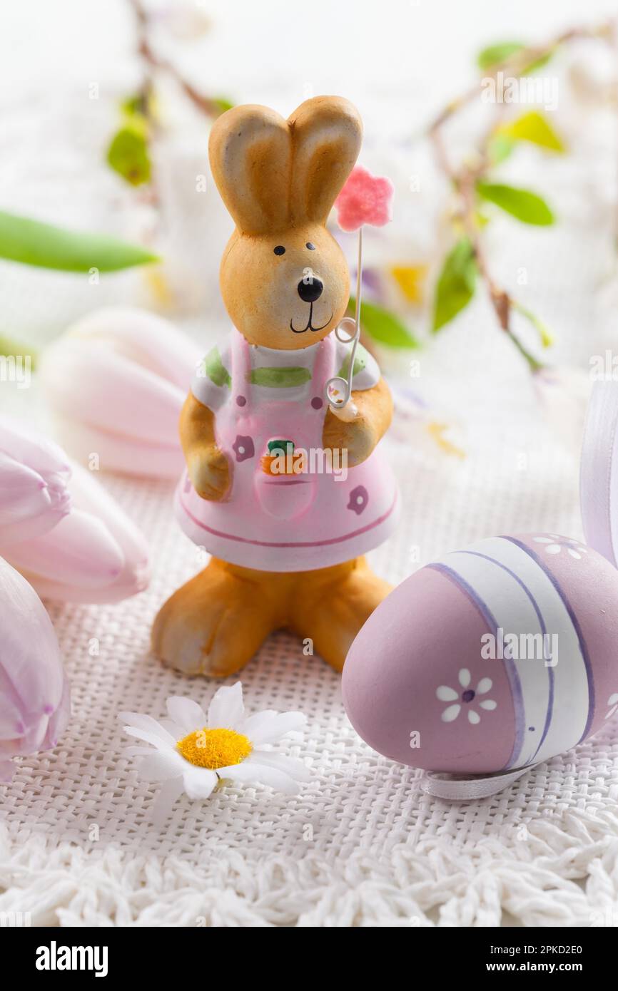 Easter bunny with painted eggs with fresh tulips Stock Photo - Alamy