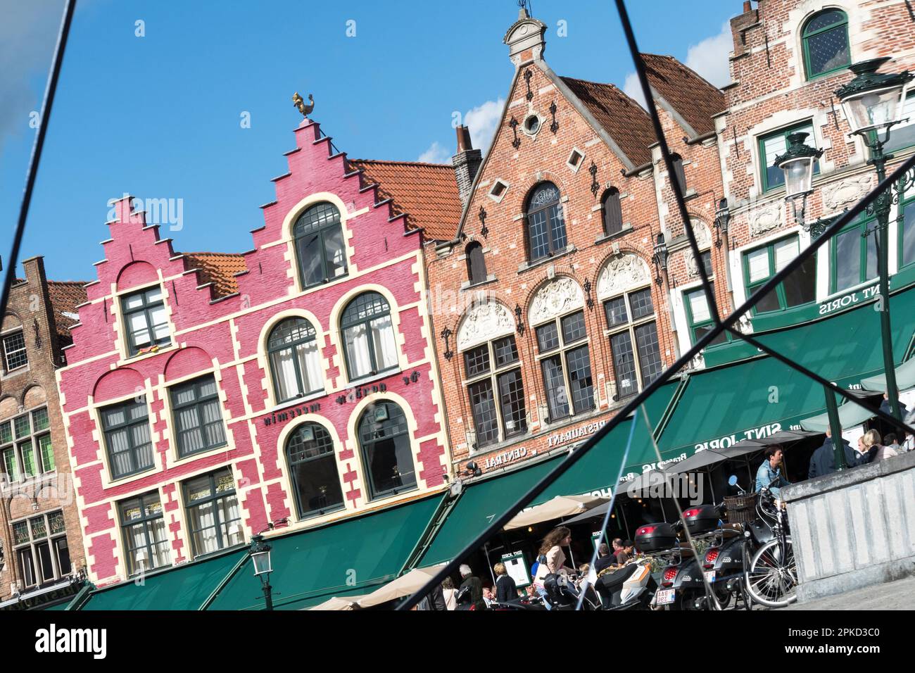 Split mirror of historic gabled buildings and cafes in Market Square