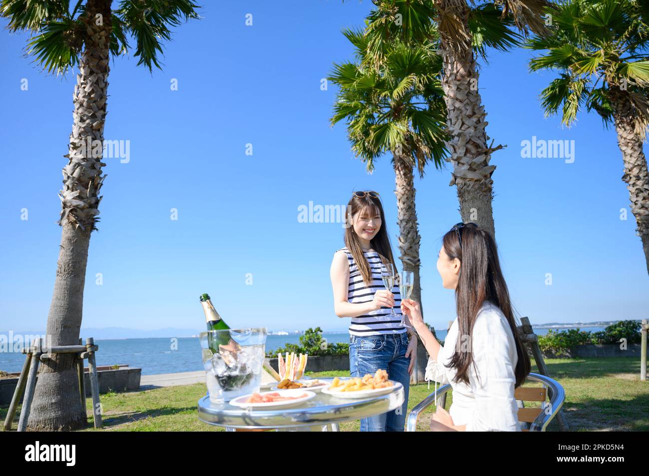 2 women dining in a sea resort Stock Photo