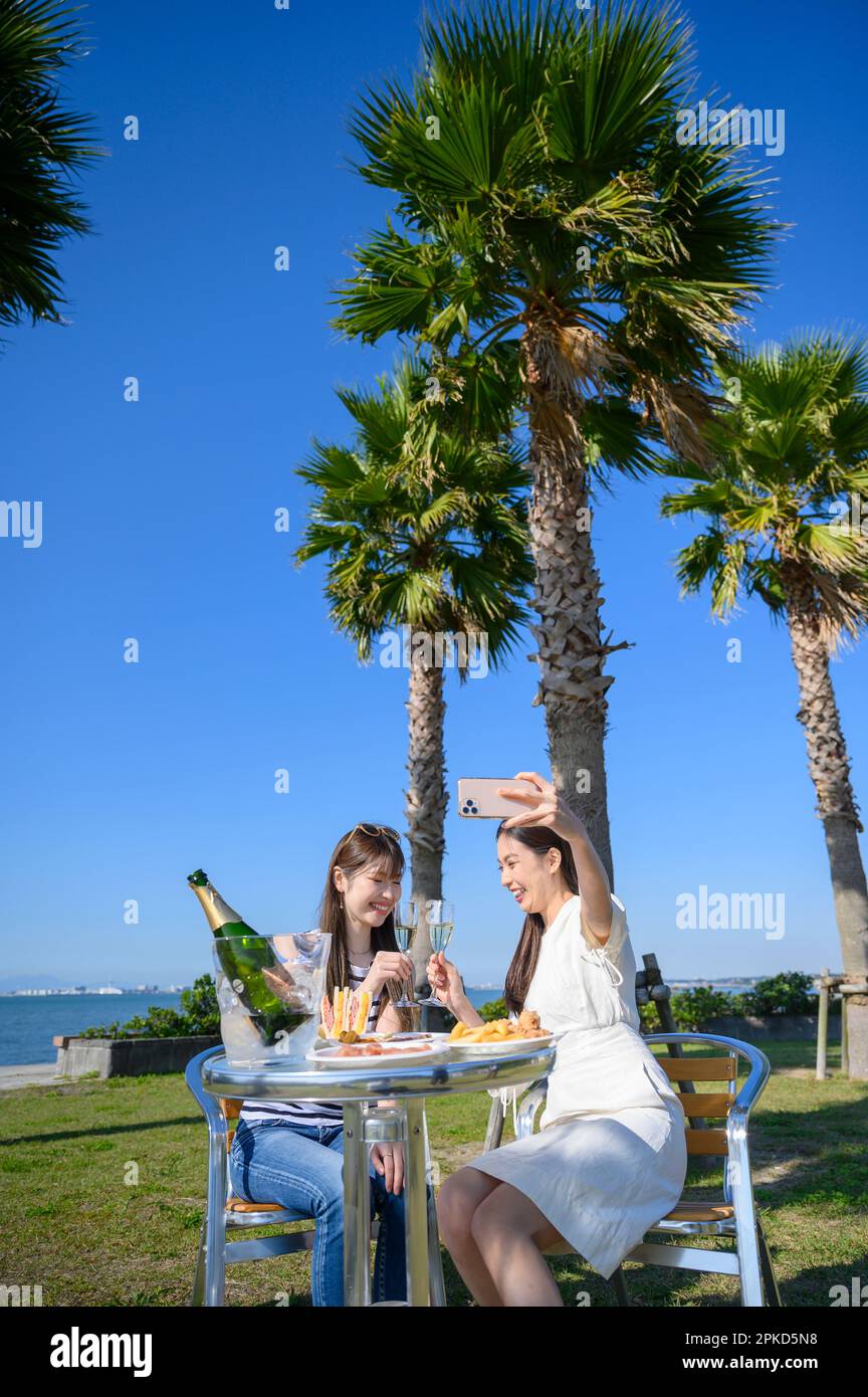 2 women dining in a sea resort Stock Photo