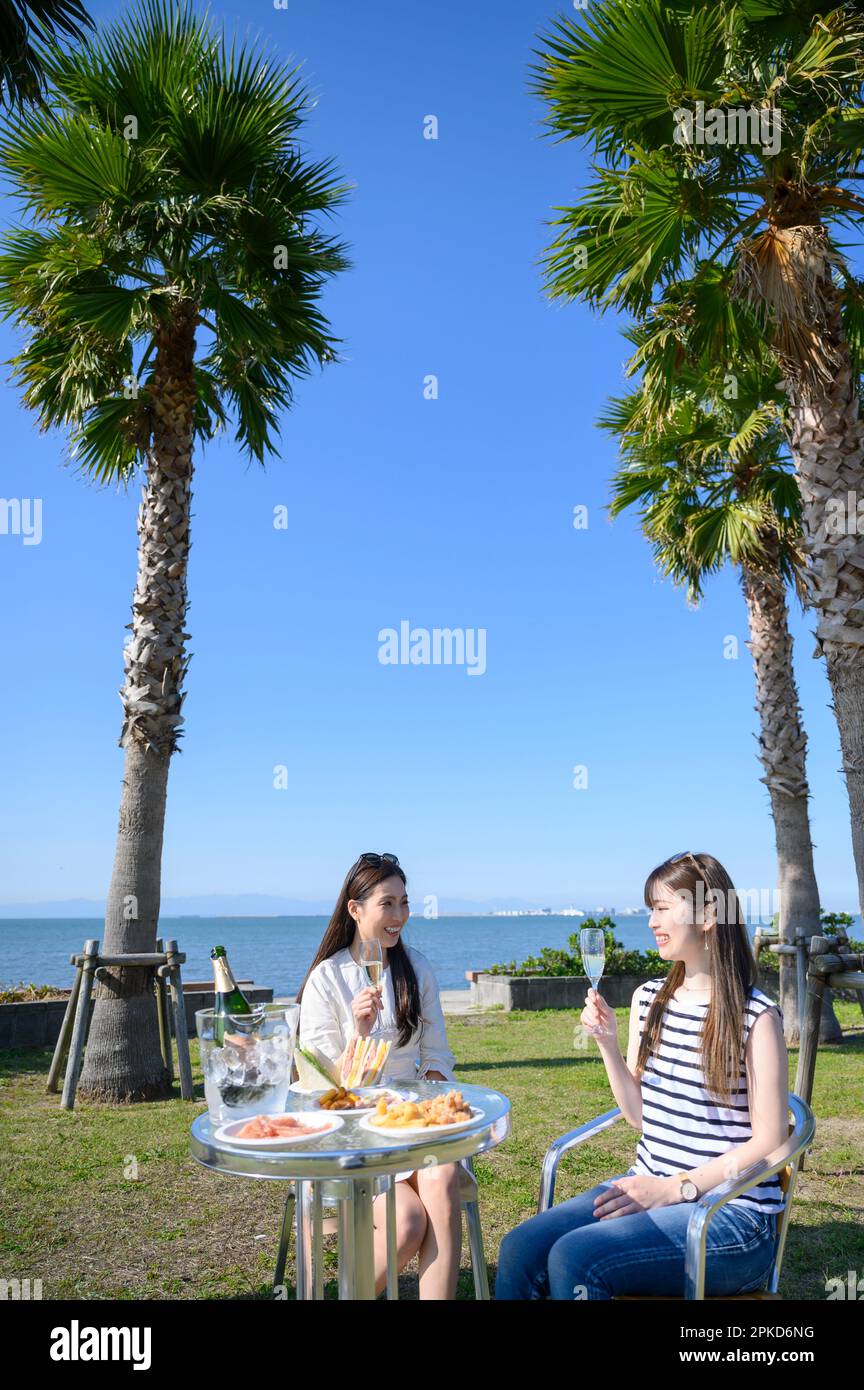 2 women dining at a sea resort Stock Photo