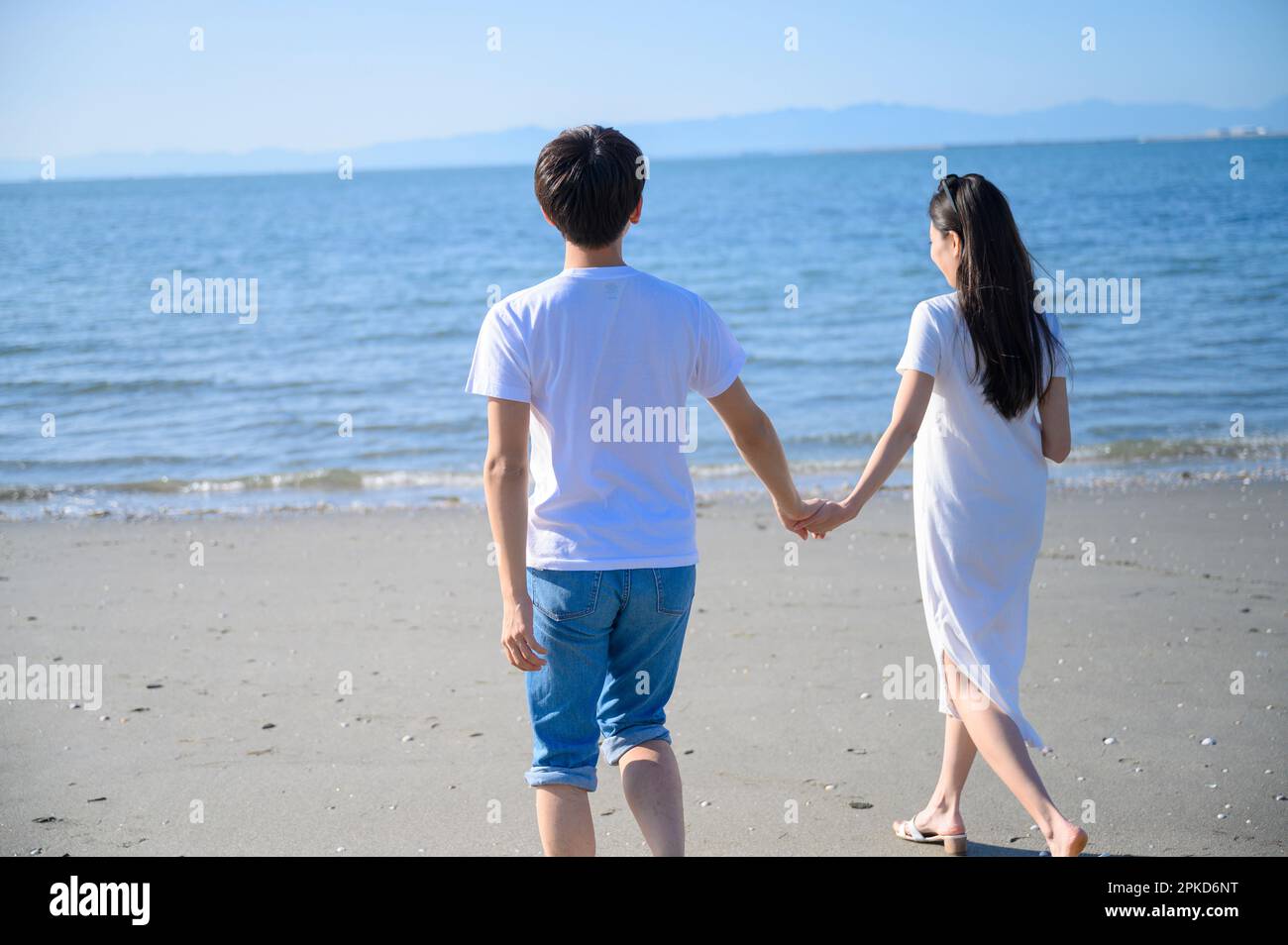 Couple taking a walk on the beach Stock Photo