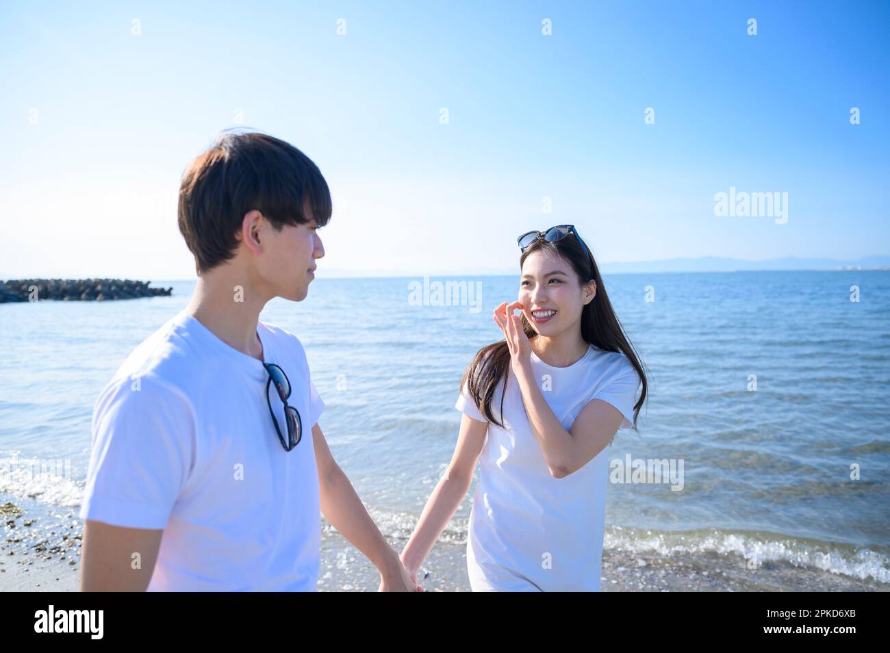 Couple strolling on the beach Stock Photo