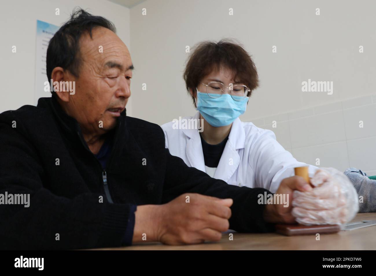 LIANYUNGANG, CHINA - APRIL 7, 2023 - A medical worker rehabilitates a patient at Luhe Community Health Center in Guanyun County, Lianyungang City, Eas Stock Photo