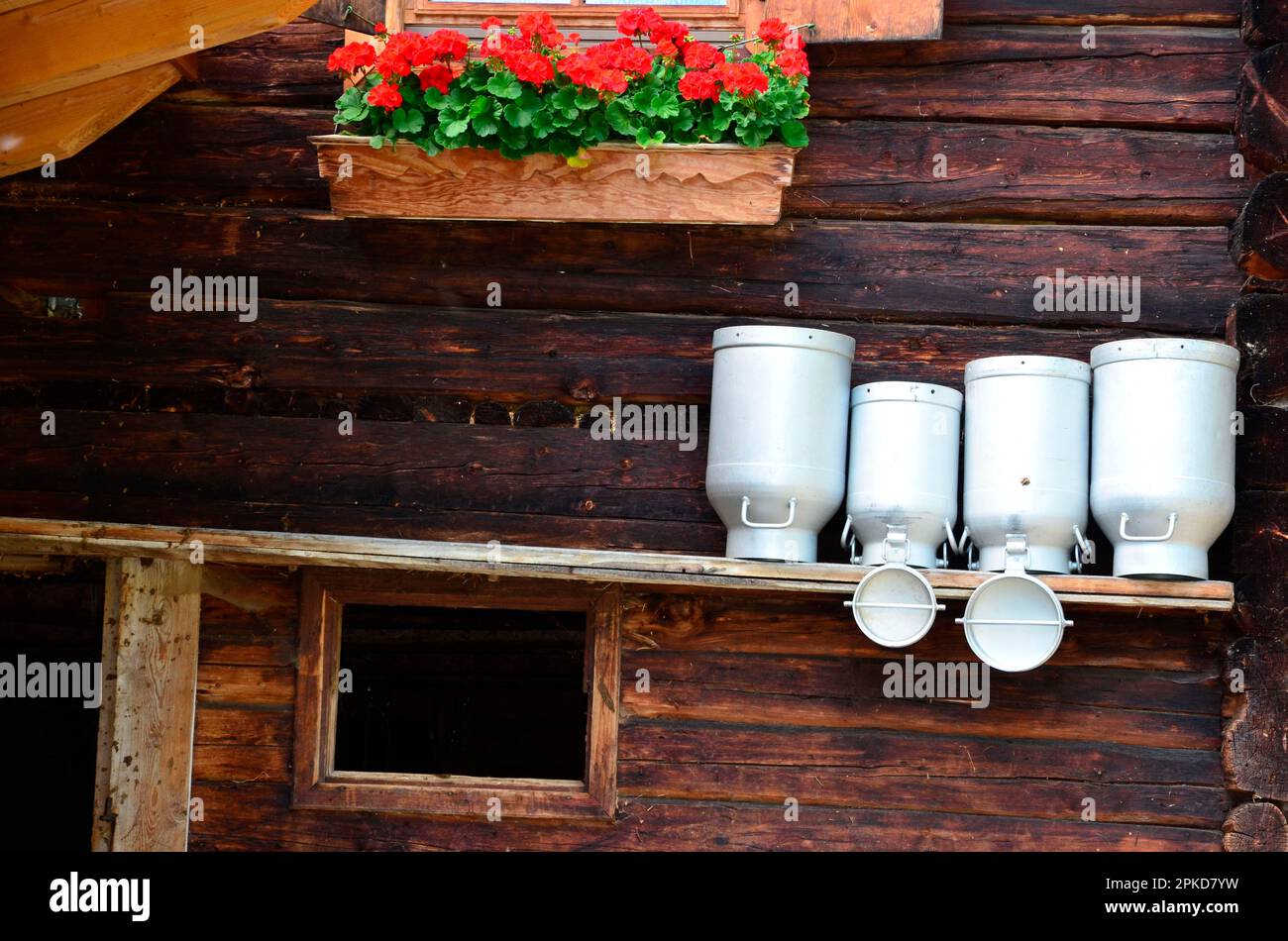Country idyll, barn, milk cans, flower box Stock Photo