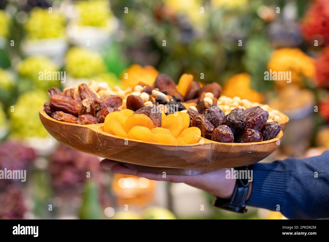 Mixed nuts platter. Wood nut plate prepared with hazelnuts, cashews