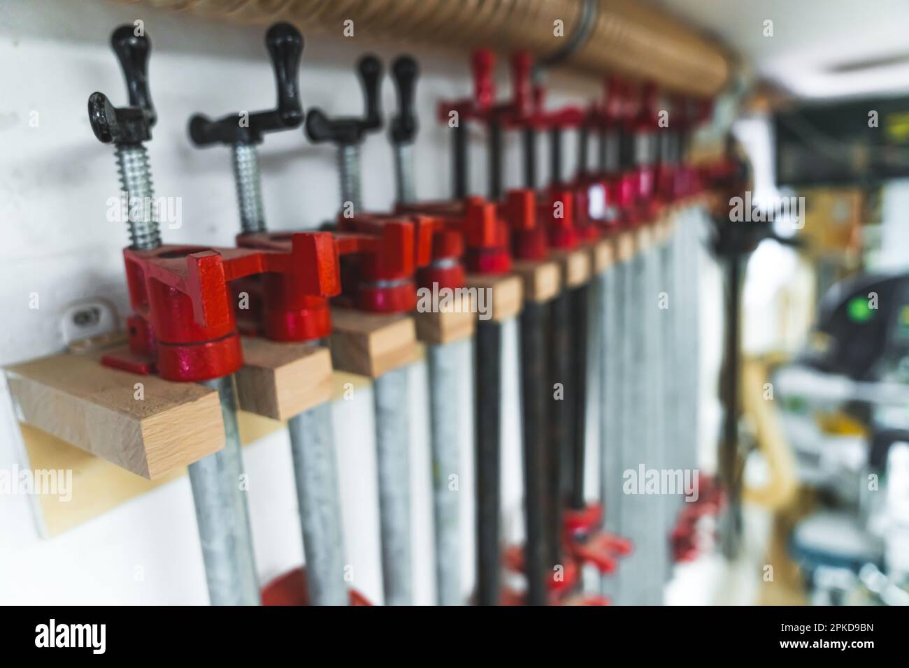 Group of bar clamps used in woodworking for glueing pieces together