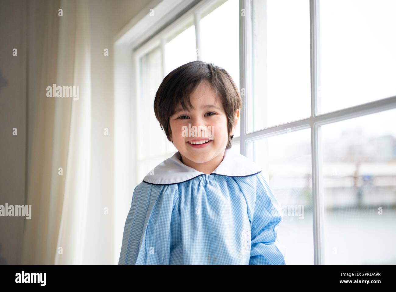 Smiling preschooler by the window Stock Photo