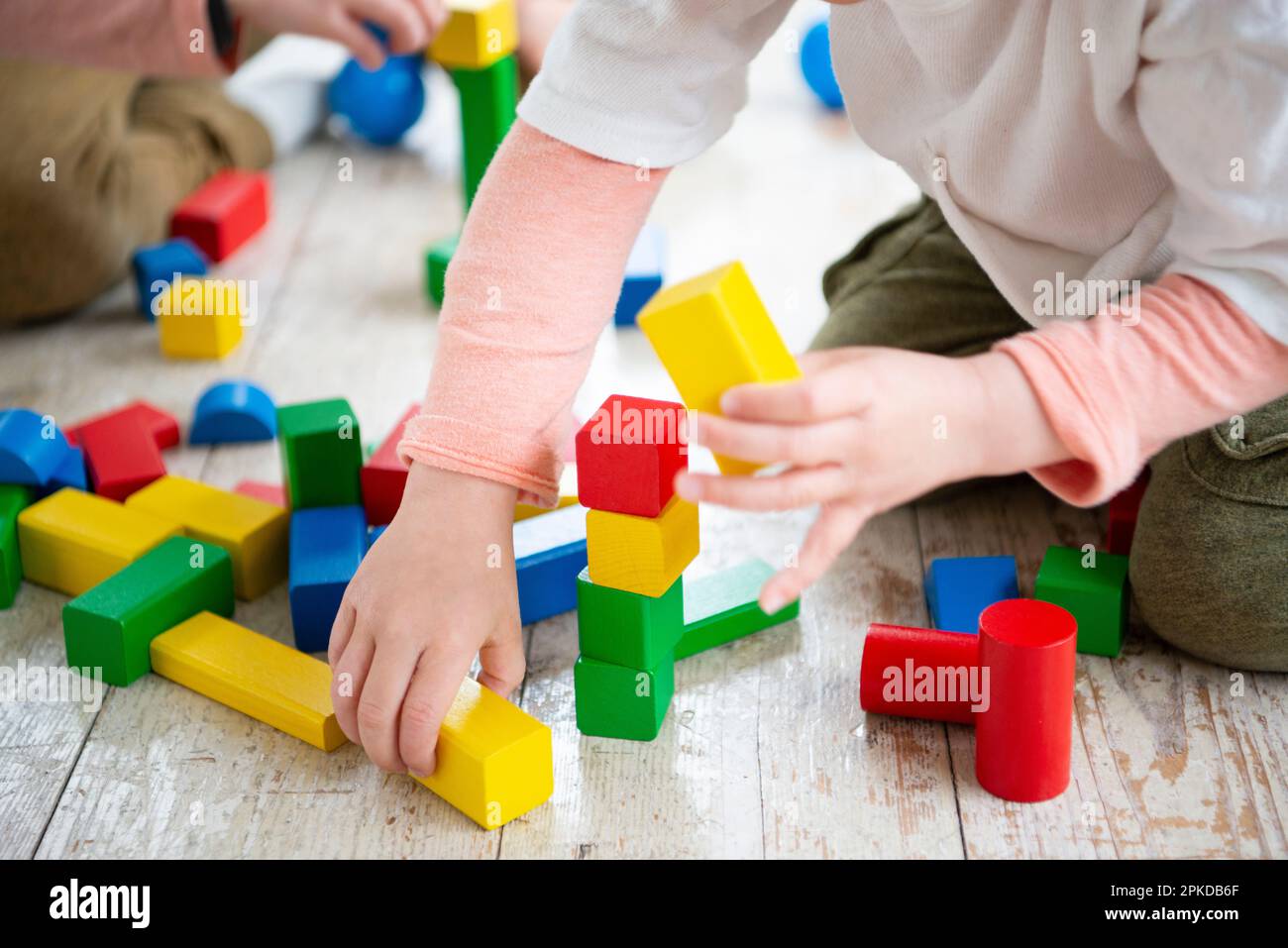 Children playing with building blocks Stock Photo