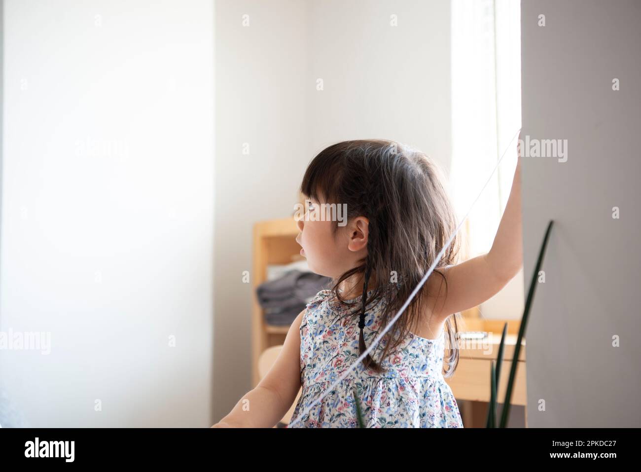 Girl playing inside house Stock Photo