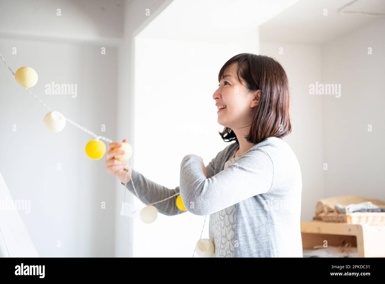 Woman decorating inside a house Stock Photo