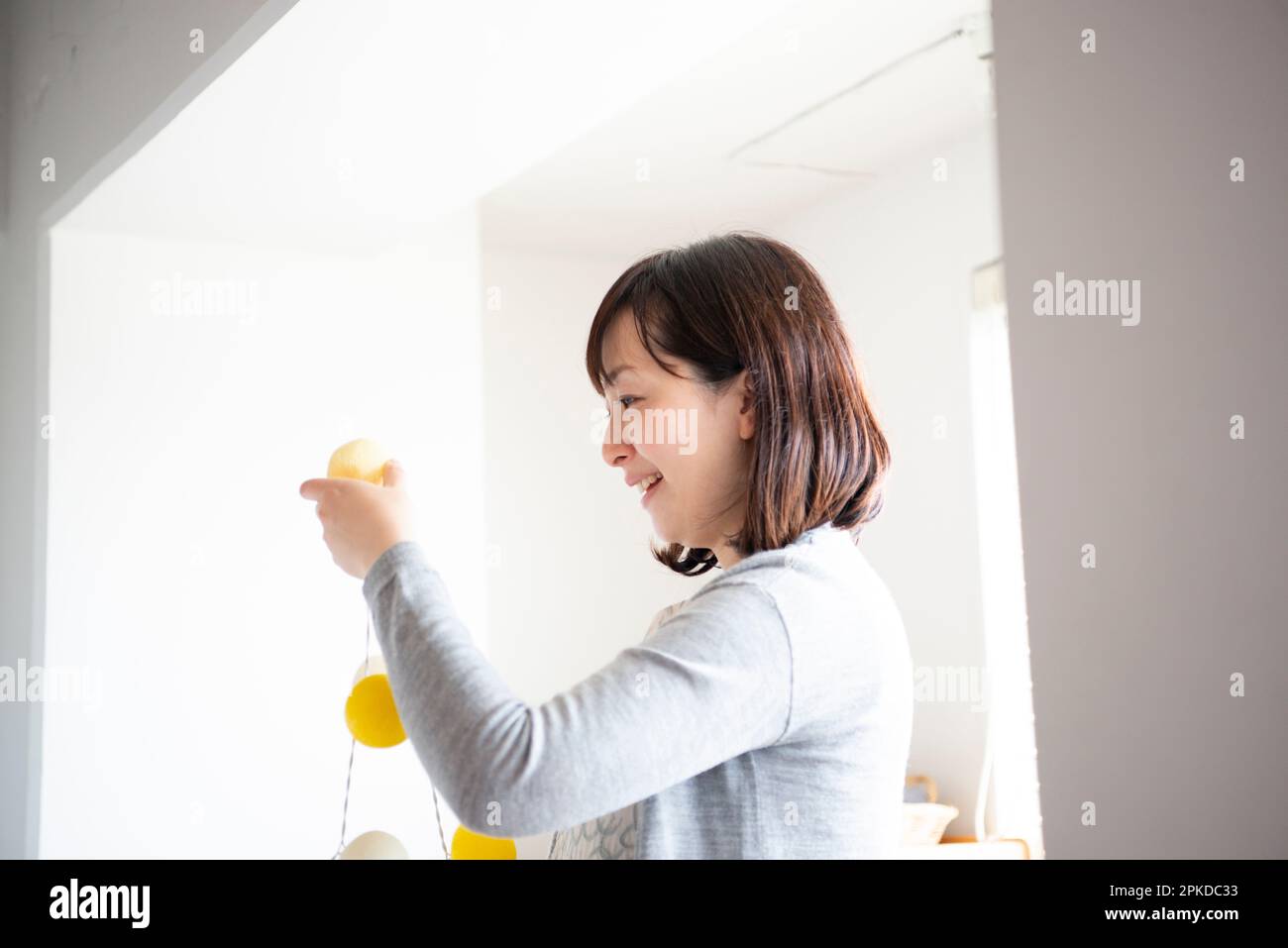 Woman decorating inside house Stock Photo