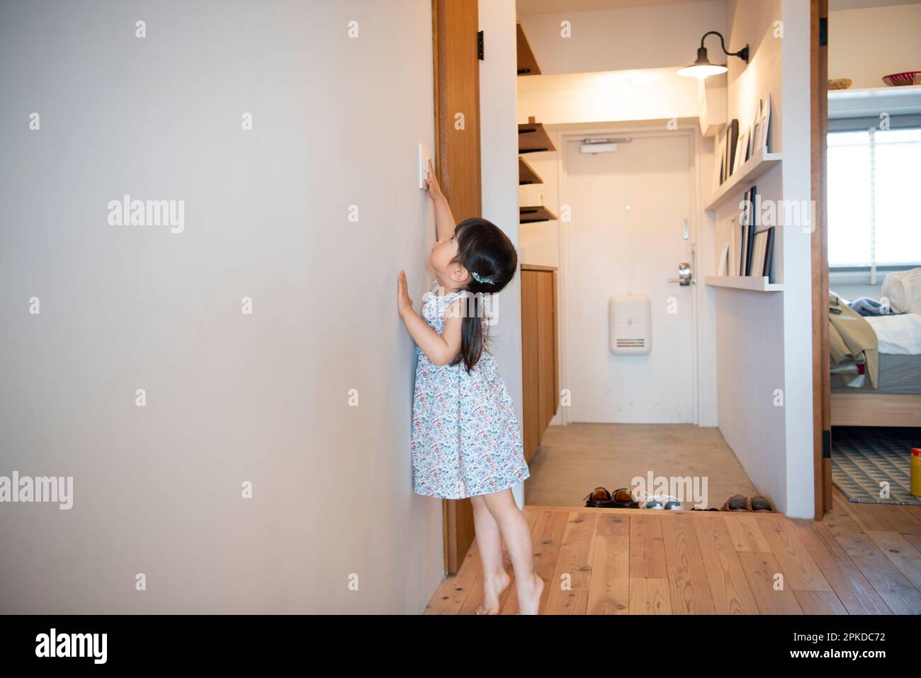 Girl Touching Light Switch Stock Photo