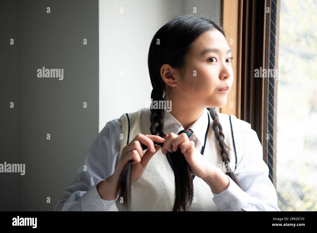 High school girl with her hair tied up Stock Photo Alamy