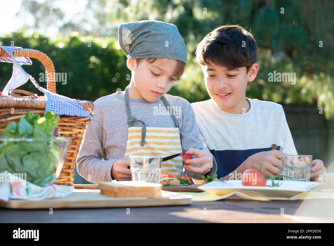 Brothers making sandwiches in the garden Stock Photo