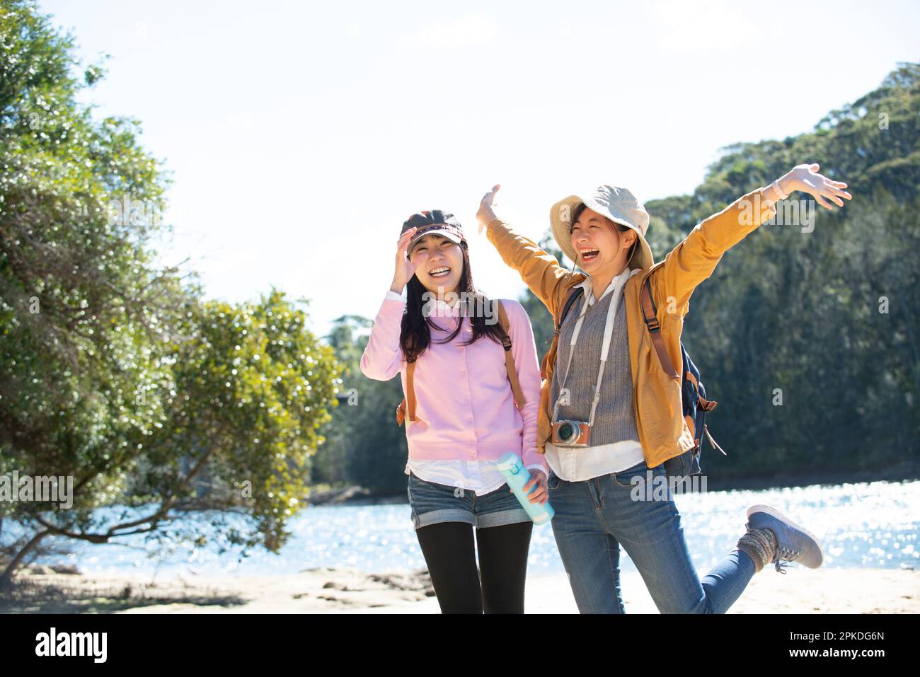 Two women posing by the riverside Stock Photo