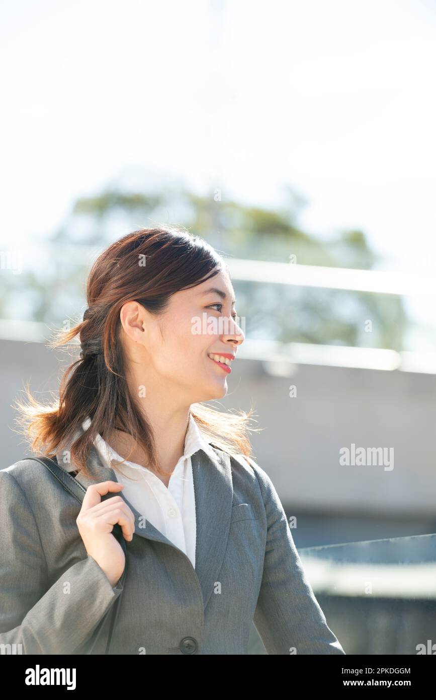 Side view of a woman in a suit smiling Stock Photo