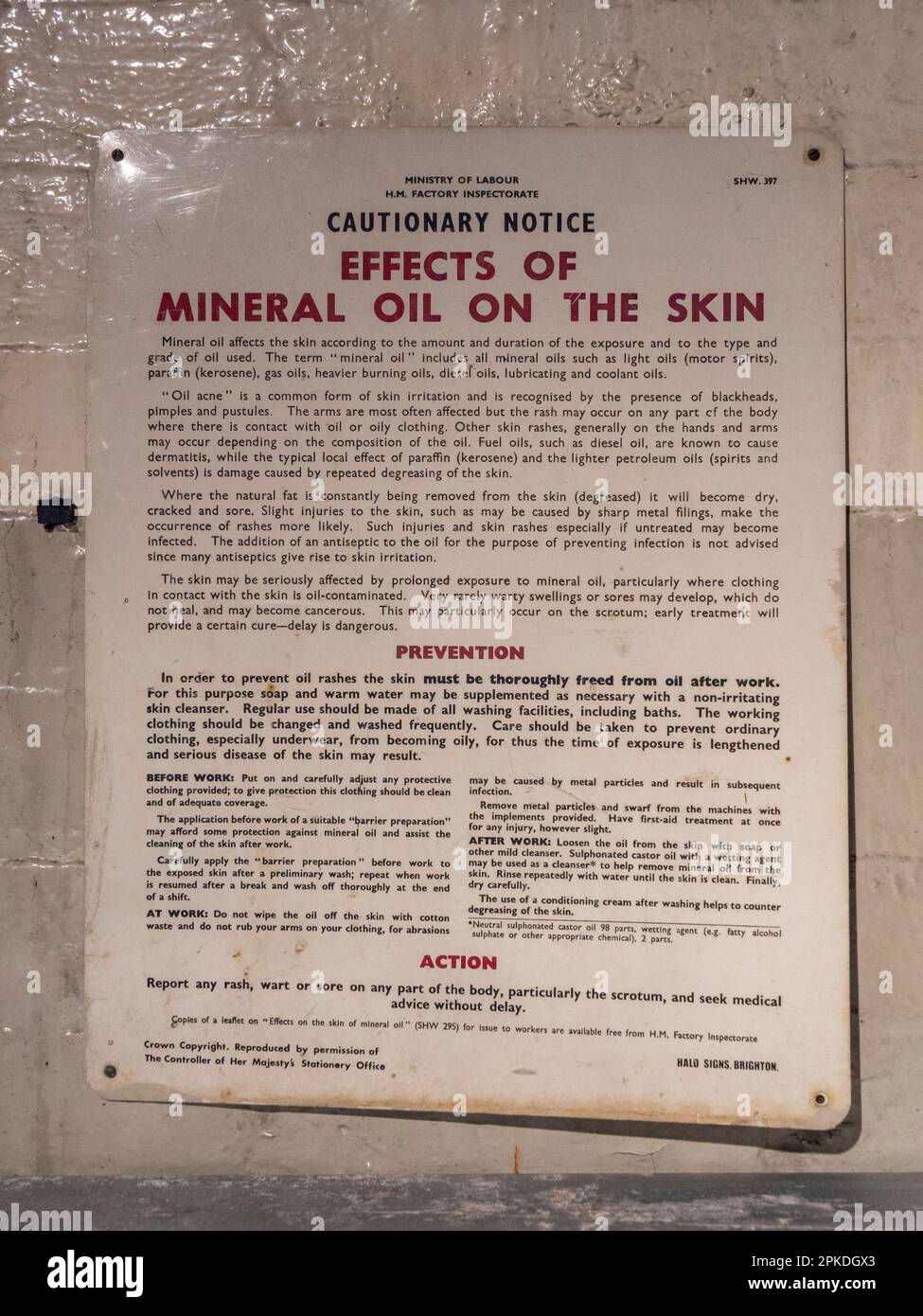 Staff notice warning about dangers of 'mineral' oil on the skin at Mail Rail, the former Post Office Railway system in central London, UK. Stock Photo