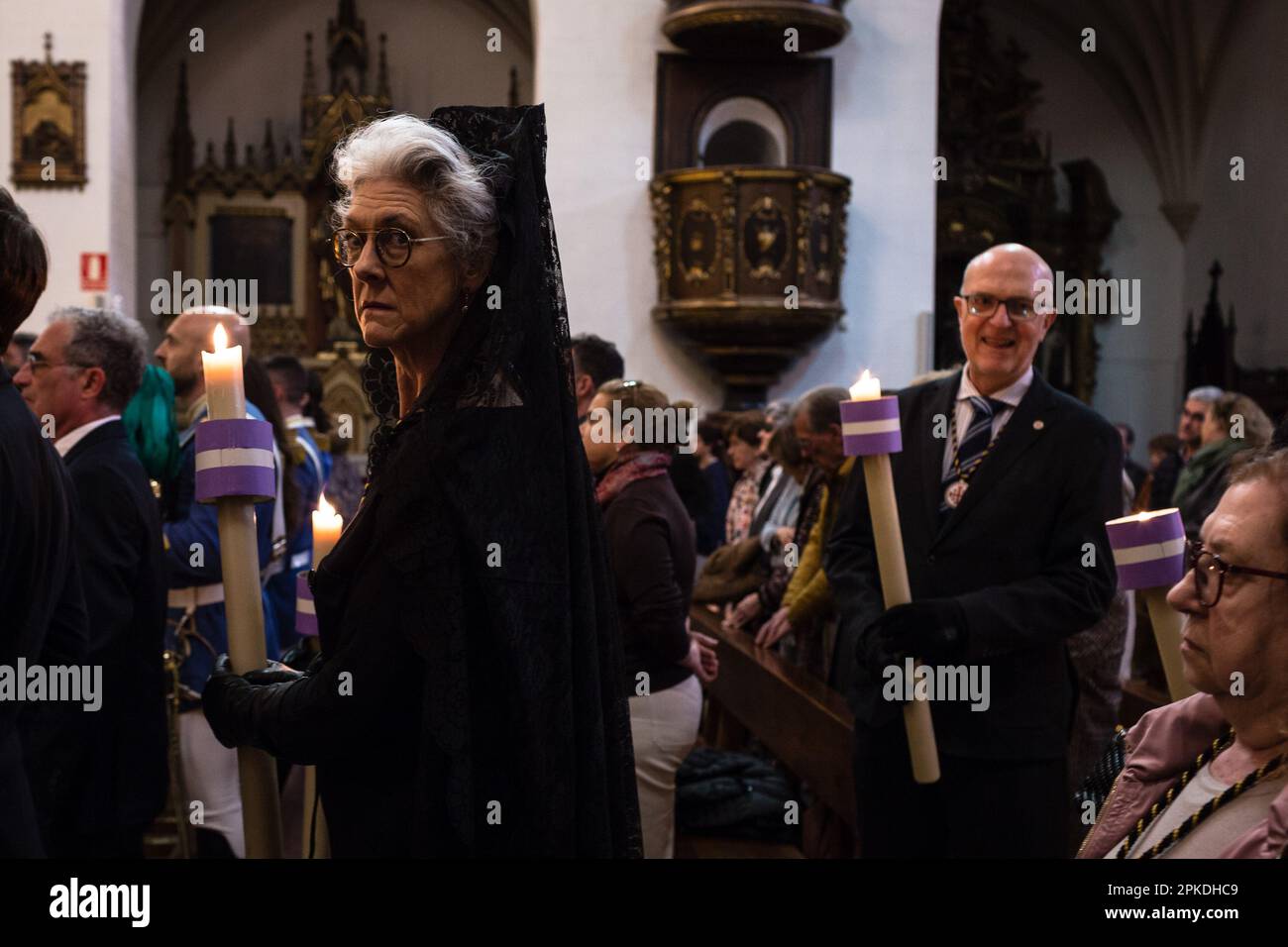 Pamplona, Spain. 06th Apr, 2023. A woman who participates in the mass for the renewal of the Vows of the Five Wounds looks at the camera while holding a candle in her hands. The act of renewal of the Vow of the Five Wounds is carried out once a year, every Holy Thursday, and it is a celebration that dates back to the year 1599 when the city of Pamplona implored divine intervention to get rid of the plague that devastated entire cities of Spain. (Photo by Nacho Boullosa/SOPA Images/Sipa USA) Credit: Sipa USA/Alamy Live News Stock Photo