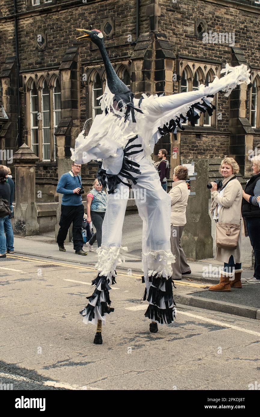 Stilt performer leads the parade at the 2015 Skipton Puppet Festival. Stock Photo