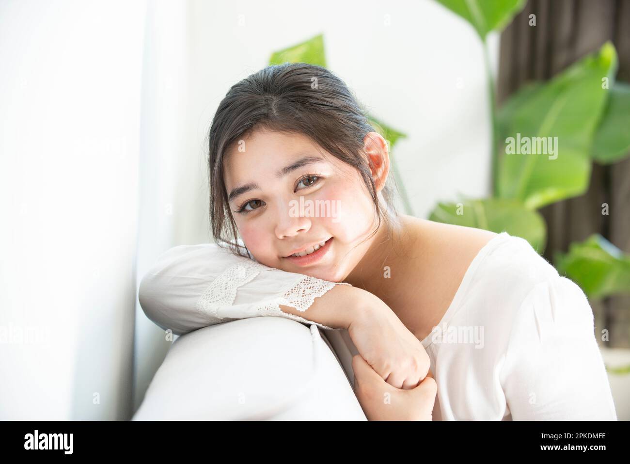 Asian woman sitting on couch hi-res stock photography and images - Alamy